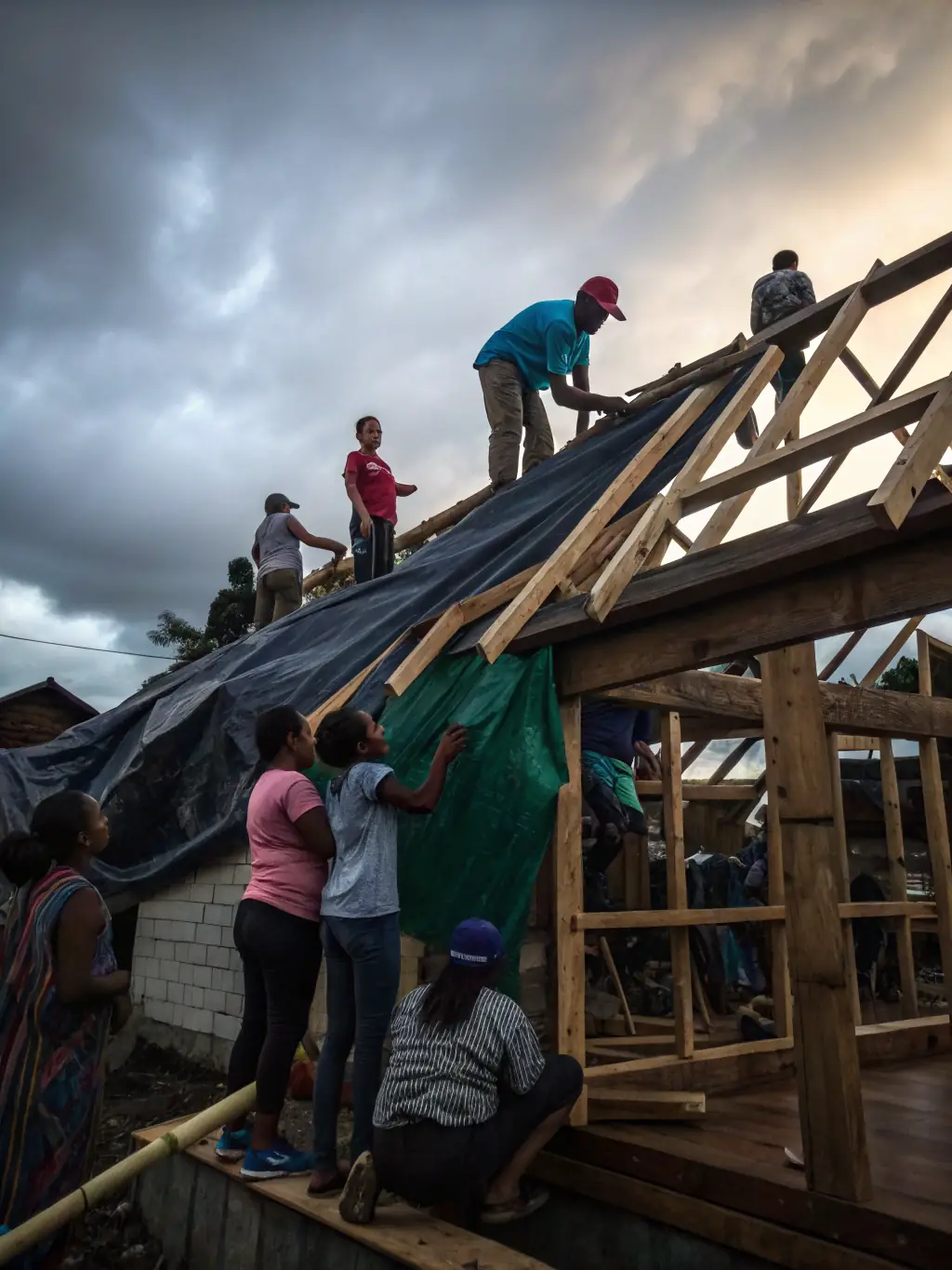 A photo of volunteers assisting a family with home repairs, showcasing the organization's commitment to improving living conditions for residents in need.